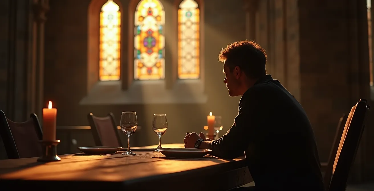 Une personne assise seule à une table dans une chapelle historique, la lumière filtrant par les vitraux créant des motifs géométriques sur les murs anciens.